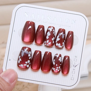 Cat eye press-on nails in burgundy with white floral and butterfly hand-painted art