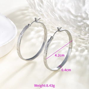 Detailed view of silver hoop earrings showing 4.2cm diameter and star pattern texture