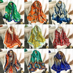 Detailed display of silk satin scarves in diverse vintage black and gold floral patterns