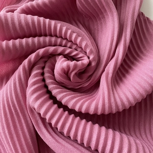Macro detail of pleated pink cotton-linen fabric texture for scarves and headwraps