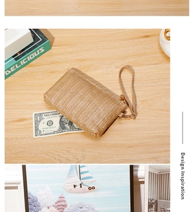 Detail of straw woven wallet with wristlet strap and zipper closure, size compared to dollar