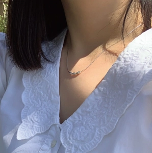 Elegant s925 silver snake chain necklace with three olive beads on a model neckline
