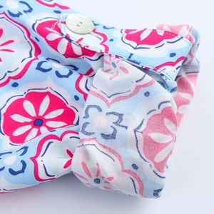 Close-up of sleeve cuff with button and blue-pink geometric floral cotton linen fabric