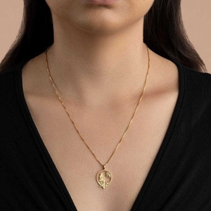 Gold Greek goddess necklace with bird and leaf pendant worn on neck