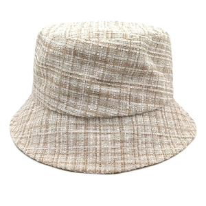 Stylish beige tweed bucket hat with textured woven fabric for women on white background