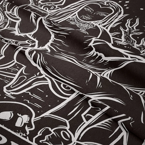 Macro detail of gothic tarot tapestry showing black and white skull and woman print