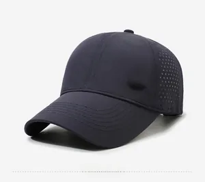 Detail of laser-cut side vents and metal sports logo on quick-dry navy blue baseball cap