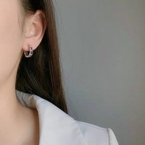 Rainbow gemstone hoop earrings in silver plating shown on model for a stylish look