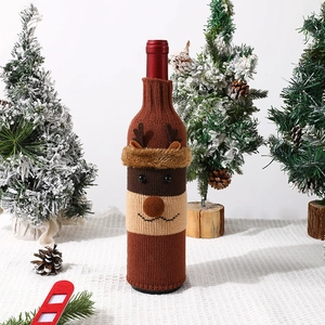 Close-up of brown knitted reindeer wine bottle cover with soft plush trim for Christmas