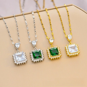 Detail of square halo necklaces with emerald green and clear zircon stones in gold and silver