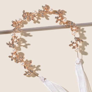Elegant gold bridal headband with pearl and rhinestone leaf patterns and white silk ribbons