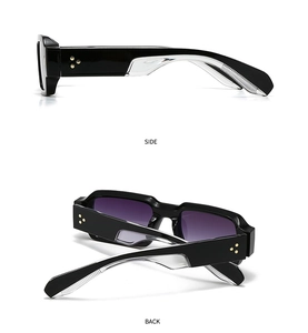 Detail view of black square sunglasses with gold star rivets and purple lenses