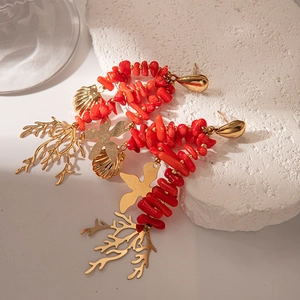 Elegant gold starfish and red coral tassel drop earrings for a luxury beach resort look