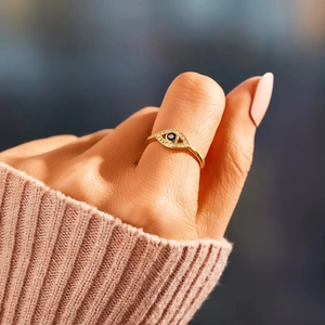 Golden S925 sterling silver evil eye open ring with blue zircon worn on thumb