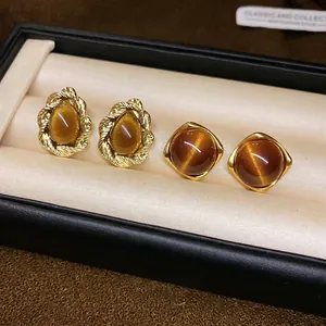 Tiger eye stone earrings set with golden twist frames and square studs for women