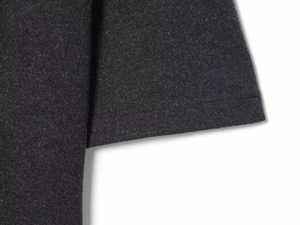 Close-up of fine stitching and soft knit fabric texture on this black belted dress