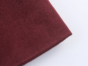 Detailed close-up showing the soft texture of burgundy suede fabric on this coat