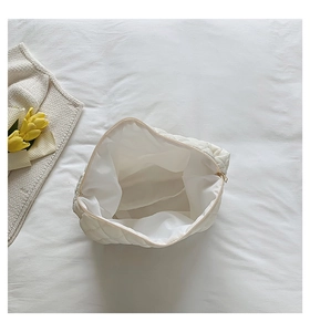 Top view of spacious white dumpling bag showing inner lining and zipper closure