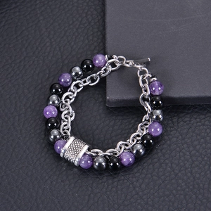 Detailed macro of men's beaded bracelet with tiger eye stones and metal OT buckle