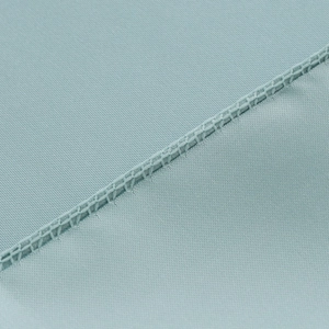 Close-up of light blue satin table runner fabric showing fine texture and stitching details