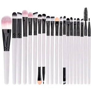 Flat lay of 20-piece makeup brush set with white handles and pink-white gradient bristles