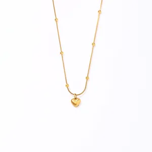 Detail view of 18K gold heart pendant with beaded chain dimensions 45cm length and 4.2g weight