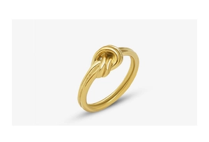 Macro view of polished 18k gold-plated titanium steel ring with minimalist knot design