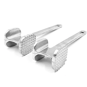 Detail showing two-sided stainless steel meat tenderizer with textured and flat heads
