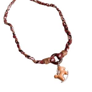 Handmade woven fabric necklace with retro wooden rocking horse pendant and ethnic paisley patterns