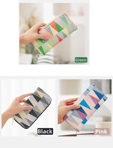Close-up of long zip wallets featuring geometric triangle patterns in green, black, and pink