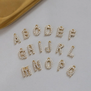 Close-up of 18k gold plated alphabet charms with cubic zirconia for DIY jewelry making