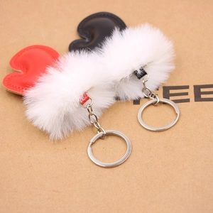 Close-up of heart-shaped plush and leather keychains in red and black colors