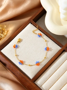 Detail of flower beaded chain bracelet with adjustable lobster clasp in 18K gold finish