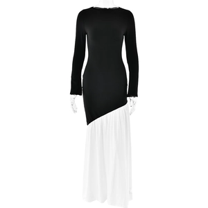 Front view of elegant black and white color block maxi dress with long sleeves and pleated skirt