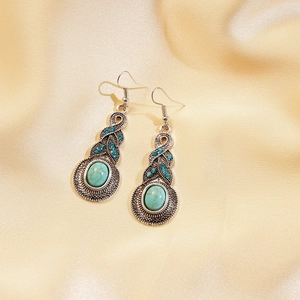 Detail showing vintage bohemian drop earrings with turquoise stones and blue rhinestones