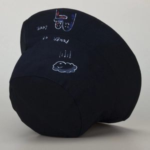 Detail of artistic graffiti print with Power of Love text on black cotton bucket hat