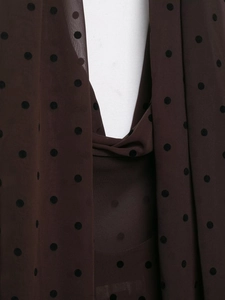 Detail of dark brown sheer chiffon fabric with black polka dots and layered texture