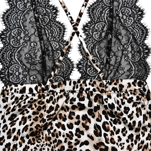 Close-up of sexy backless leopard satin dress with black lace trim and thin cross straps