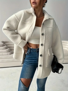 Women's white fuzzy teddy coat featuring a long loose fit and black button details