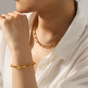 Hammered texture gold link necklace and bracelet set shown on a model for women