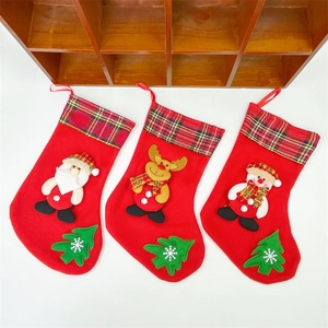 Detailed view of red Christmas stockings with Santa, reindeer and snowman plush designs