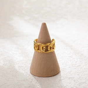 Close-up of golden chain link ring on a display stand showing 18K gold plated detail