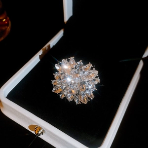 Close-up of shimmering flower-shaped ring with marquise and pear-cut crystals in a box