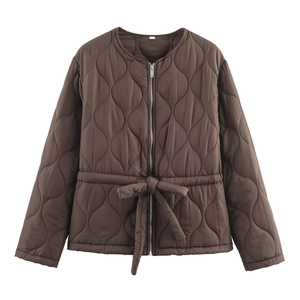 Detail of diamond-quilted brown jacket featuring a drawstring waist and metal zipper