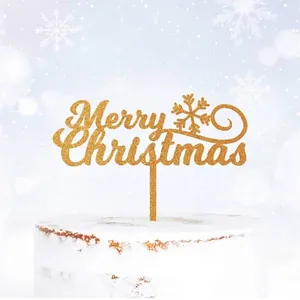 Glittering gold Merry Christmas cake topper with snowflake on a white cream cake