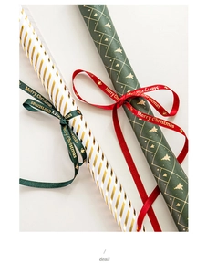 Detail of Christmas gold stamping ribbons and wrapping paper rolls with festive patterns