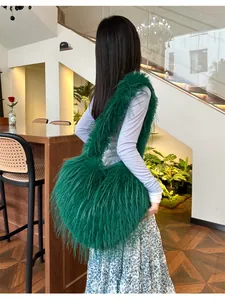 Detail of emerald green fuzzy plush shoulder bag with long faux fur texture and large capacity