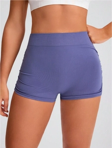 Detail view of high-waist seamless knitted sports shorts with ribbed support in mauve