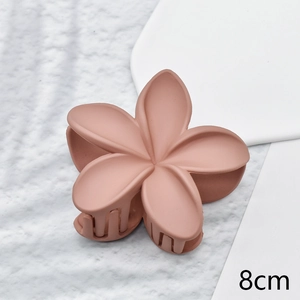 Macro shot of 8cm coral pink matte flower hair claw clip with smooth resin finish