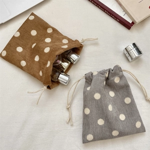 Polka dot corduroy drawstring storage pouches in brown and gray for cosmetics